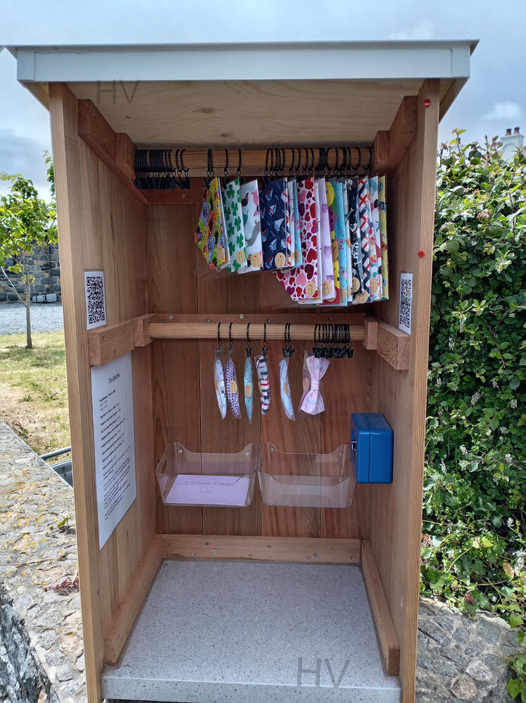 a local hand made road side craft stall wooden shed surrounded by roses
